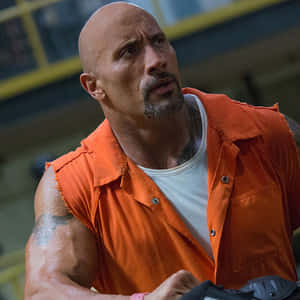 Dwayne Johnson 身穿橙色監獄連身衣在健身房向上看 — 狂野時速 壁紙