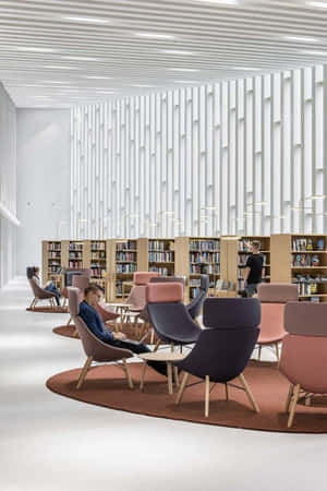 人們在現代圖書館閱讀，館內有色彩繽紛的椅子和書架。