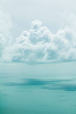 柔軟的白雲下，寧靜的藍綠色海洋，地平線平靜。 — 唯美雲朵動態 壁紙