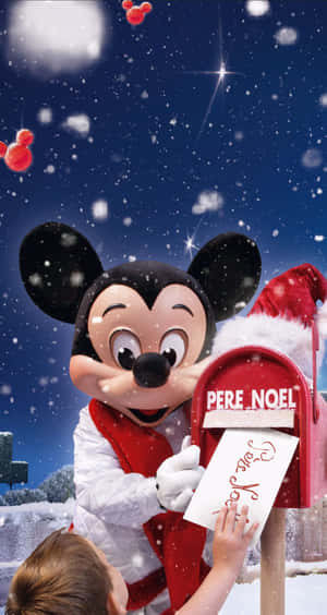 戴聖誕帽的米奇老鼠在雪中將信送到Pere Noel郵筒。