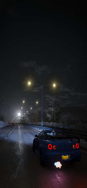 夜間街燈下，藍色跑車在積雪的高速公路上飛馳。