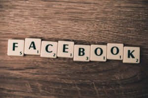 Scrabble字母磚喺木背景上拼出facebook