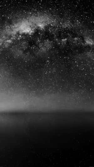 黑暗地平線上方銀河系閃耀的星空夜晚。 — 月色夜空 壁紙