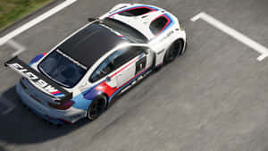 一架BMW M6 GT3賽車在賽道上疾馳，帶有動態模糊效果。 — 低調 壁紙