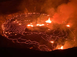 夜晚的火山口，發光的熔岩在表面流動。