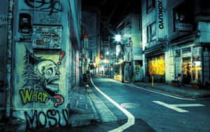 東京夜晚佈滿塗鴉的小巷，帶有骷髏壁畫和霓虹招牌。 — 日本 壁紙
