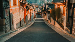陽光普照的狹窄街道，傳統韓國建築和背景中的現代城市天際線。