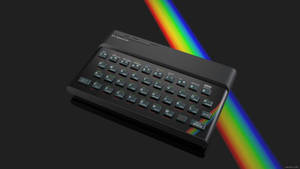 深色背景上帶有彩虹光束的黑色Sinclair ZX Spectrum電腦 — 合成波 壁紙