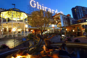 吉拉德里廣場黃昏，燈光建築物和人魚噴泉。 — 夜晚 GIF 壁紙