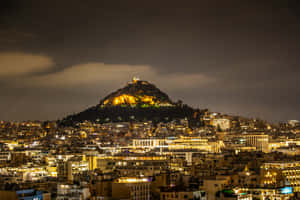 城市夜景，山頂有照明紀念碑和密集建築。 — 夜空 壁紙