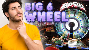 身穿黃色襯衫的男子在賭場Big Six輪盤遊戲旁思考。