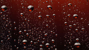 深紅色漸變背景上的水滴抽象圖案。 — 夜晚 GIF 壁紙