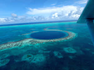 俯瞰藍色環礁，擁有碧綠海水和珊瑚礁。 — 藍天 壁紙