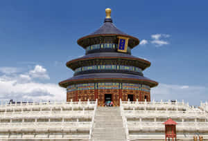 圓形中國寺廟，藍色屋頂和紅色柱子，位於大理石台階上，天空晴朗。 — 中國 壁紙