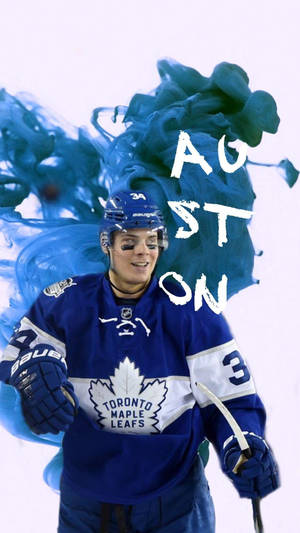 冰球運動員 Auston Matthews 身穿藍色多倫多楓葉隊球衣，搭配旋轉的藍色墨水及白色名字。 — 藍色 壁紙