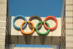 奧運五環安裝在現代建築上，在清澈的藍天下。