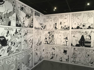 姆明漫畫面板展示在畫廊牆上，帶有對話氣泡。 — 黑白 壁紙