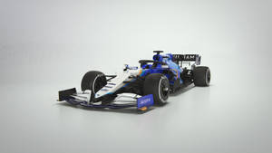 工作室中帶有 Acronis 品牌標誌的藍白一級方程式賽車。 — 汽車 壁紙