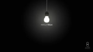 一個發光的燈泡，下方有'NIKOLA TESLA'文字，背景黑暗。 — Tesla GIF 壁紙