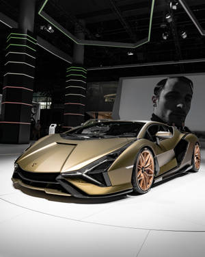 金色林寶堅尼跑車在車展上展出，配有霓虹燈光和肖像背景。