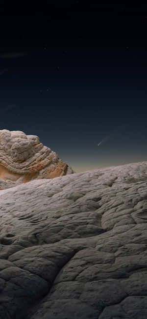 星空之夜，彗星掠過岩石沙漠景觀。