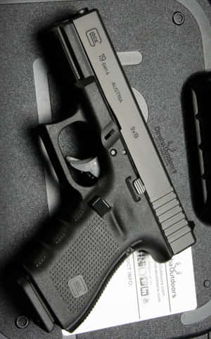黑色Glock 19 Gen 4手槍連灰色收納盒及產品卡。
