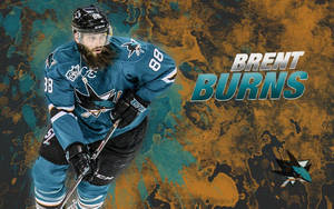 冰球運動員 Brent Burns 身穿青色鯊魚隊制服，手持球桿。 — 運動 壁紙