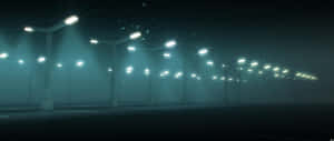 霧氣瀰漫的空蕩停車場中，一排排發光的街燈。