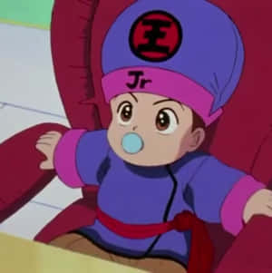 坐在紅色椅子上吹泡泡的動漫嬰兒。