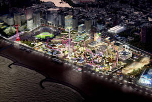 夜間燈火通明的海岸遊樂園，有過山車和城市建築。
