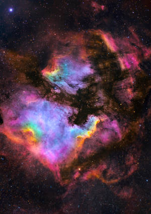 充滿活力的宇宙星雲，在太空中旋轉著粉紅色、紫色和藍綠色的氣體。 — OnePlus Pad 3 壁紙