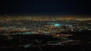 夜間從空中俯瞰廣闊城市，燈光閃爍。 — 天使 壁紙