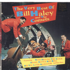 Bill Haley and The Comets 穿著紅色西裝在閃爍的舞台上表演搖滾樂。