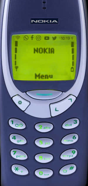 經典Nokia手機的特寫，帶有綠色屏幕和鍵盤。 — Nokia 壁紙