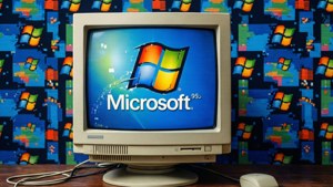 米色CRT顯示器在暗色背景上顯示Windows 98標誌和像素化Windows圖標。