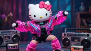 Hello Kitty 穿著粉紅色外套，在附近有卡式錄音帶的揚聲器之間跳舞。