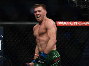 一名赤裸上身的MMA戰士在UFC八角籠內慶祝勝利。 — AMOLED 壁紙