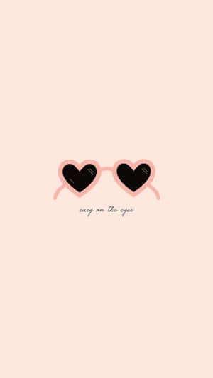 淡蜜桃色背景上帶有 easy on the eyes 文字的心形太陽眼鏡。 — 9:16 壁紙