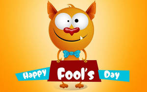 橙色卡通怪物舉住 Happy Fool's Day 牌