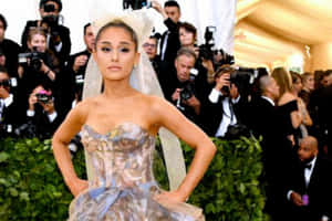Ariana Grande 穿著正式禮服和頭紗，在活動中為攝影師擺姿勢。