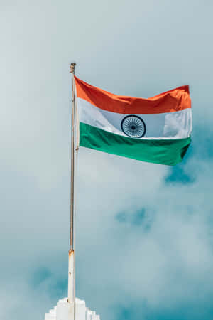 印度國旗在陰天背景下隨風飄揚。 — Huawei MatePad Air (2026) 壁紙