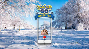 Pokémon Go社群日活動在白雪皚皚的冬季森林中，手機螢幕上顯示卡比獸。 — 可愛寵物小精靈 壁紙