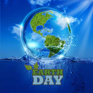 Earth Day 標誌，藍天下有玻璃地球儀和水花。