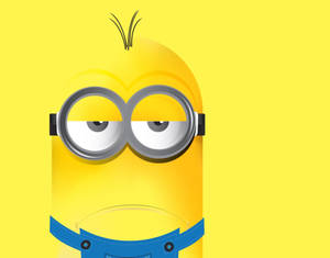 黃色背景上戴圓眼鏡同藍色工人褲嘅黃色Minion。