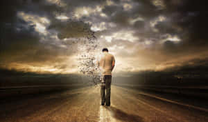 男人在空無一人的道路上行走，在黃昏的暴風雨天空下分解成粒子。 — 雲朵 壁紙