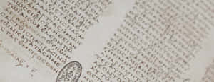 陳舊羊皮紙上古代希臘文字的近距離特寫，帶有印章。 — 聖經經文 壁紙