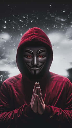 穿著紅色連帽衫和蓋伊·福克斯面具的人在雪天下祈禱。 — 鬼滅之刃面具 壁紙