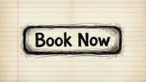 在橫線筆記簿紙上以黑色墨水手寫的「Book Now」訊息。