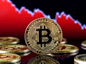 金色比特幣硬幣，背後有紅色下跌的股票圖表。 — 比特幣 壁紙