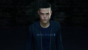 一個穿著深色連帽衫的男子，身後有發光的代碼，襯衫上寫著「Hello friend」。